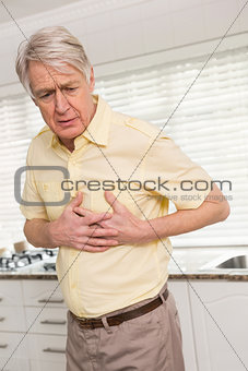 Senior man clutching his chest