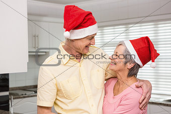 Senior couple wearing santa hats