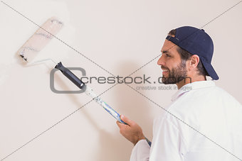 Painter painting the walls white