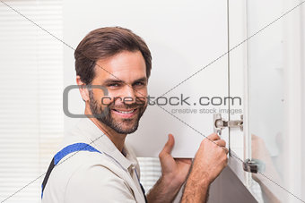 Handyman fixing the cupboard
