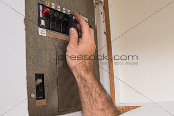 Electrician working on the fuse box