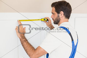 Handyman measuring a wardrobe