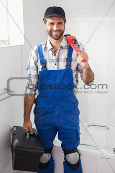 Plumber holding wrench and toolbox