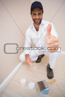 Painter showing thumbs up to camera