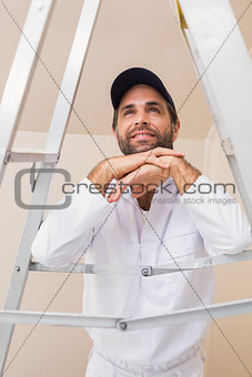 Painter smiling leaning on ladder
