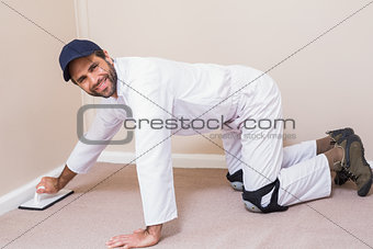 Handyman laying down a carpet