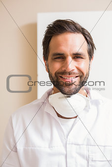 Carpenter wearing protective mask smiling at camera