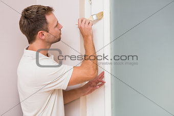 Painter painting the door white