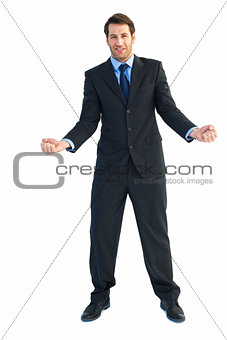 Happy businessman standing clenching his fists