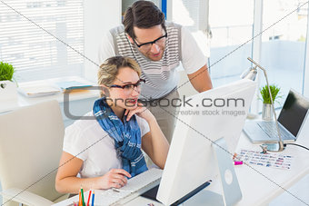 Attractive photo editor working with a colleague