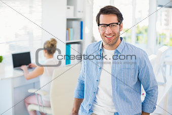 Portrait of smiling photo editor wearing reading glasses