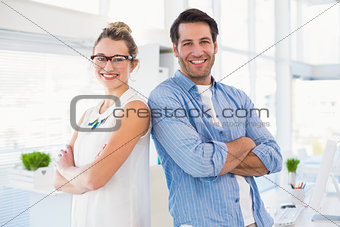 Cheerful photo editor posing with arms crossed