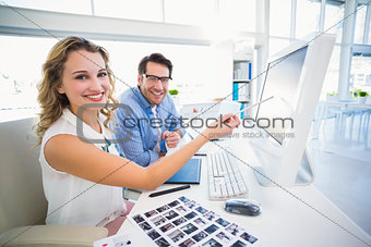 Attractive photo editor pointing at the screen