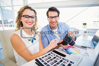 Portrait of photo editors with camera
