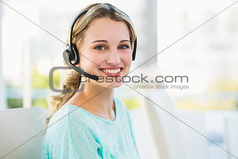 Portrait of a smiling creative businesswoman with earpiece