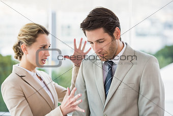 Woman shouting at male colleague