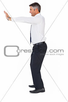 Side view of a businessman pushing