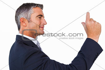 Smiling businessman looking his hand