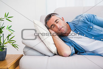 Man with grey hair sleeping on the couch