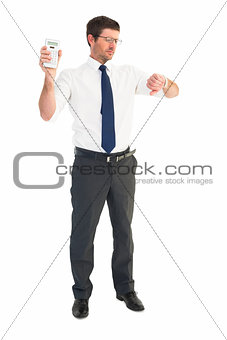 Serious businessman holding calculator checking time