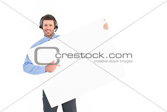 Businessman showing card wearing headset