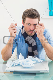 Stressed businessman looking at camera