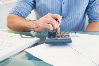 A businessman working on his finances at his desk