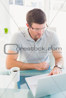 Casual businessman using his laptop at desk