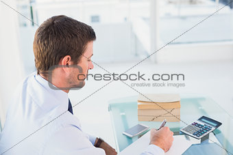Businessman working on his finances at his desk