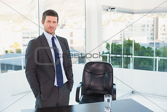 Posing businessman at his desk