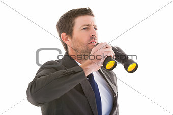 Focused handsome businessman holding binoculars