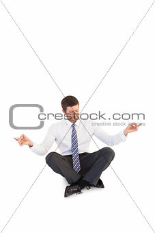 Businessman in suit sitting in lotus pose