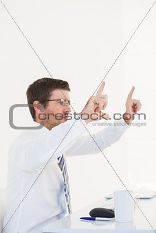 Businessman holding hands up at desk