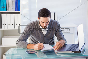 Focused casual businessman working at his desk