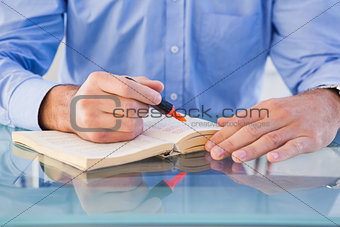 Hands highlighting text in book