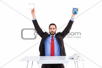 Businessman holding up reading glasses and calculator