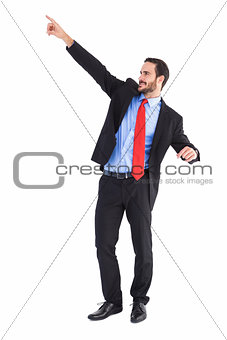 Smiling handsome businessman pointing finger