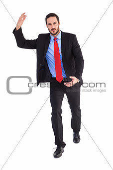 Unsmiling businessman holding something with hands