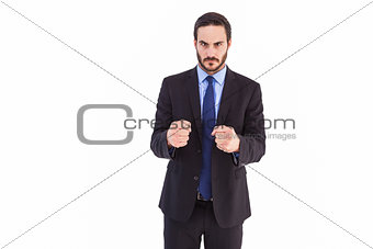 Angry businessman with closed fists looking at camera