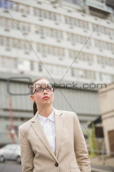 Young businesswoman looking up wearing glasses