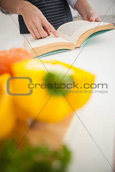 Woman following a recipe in book