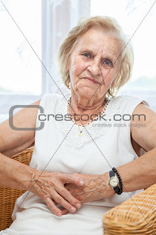 Portrait of an elderly lady sitting in a chair