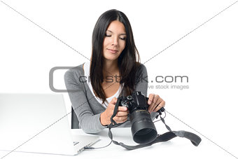 Female photographer checking an image on a camera
