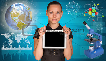 Beautiful businesswoman holding tablet PC.  Atom model and microscope beside. Globe, world map with geometric forms as backdrop