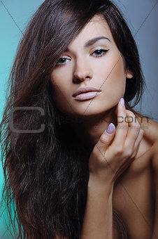 beautiful girl with perfect fresh skin and natural visage touching her face