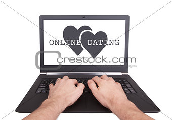 Man working on laptop, online dating