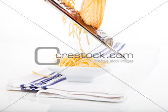 Grated cheese falling.