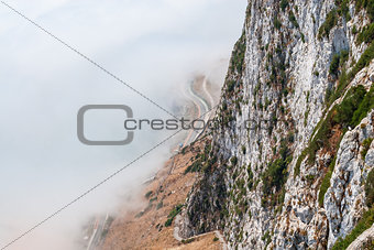 Gibraltar cliff face above fog