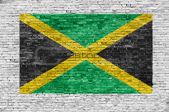 Flag of Jamaica painted over brick wall