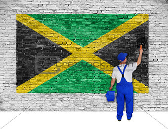 House painter covers brick wall with flag of Jamaica